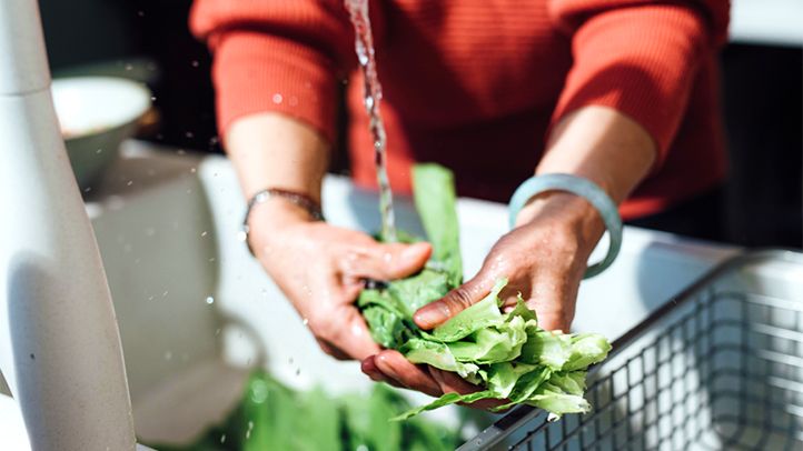 woman washing lettuce