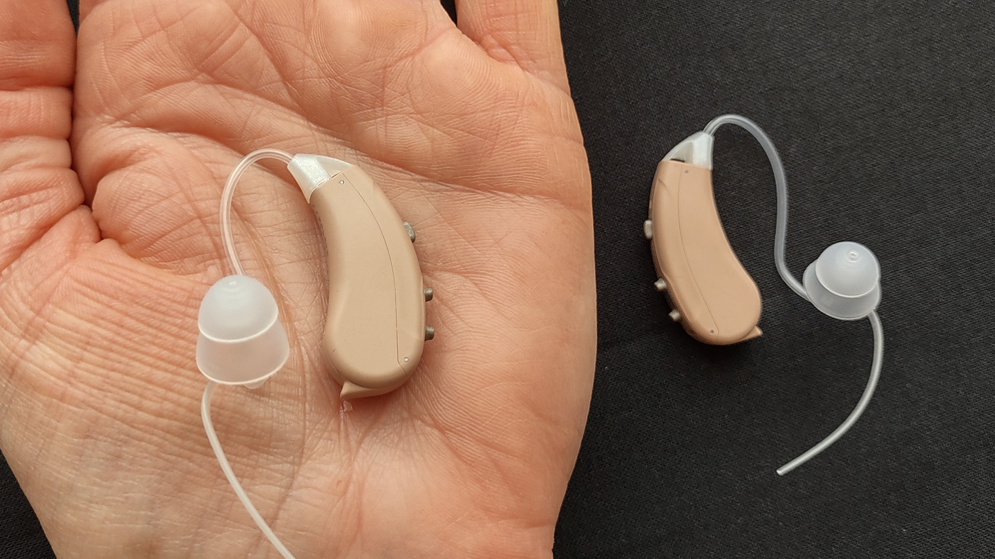 Our reviewer holding Lexie Lumen hearing aids